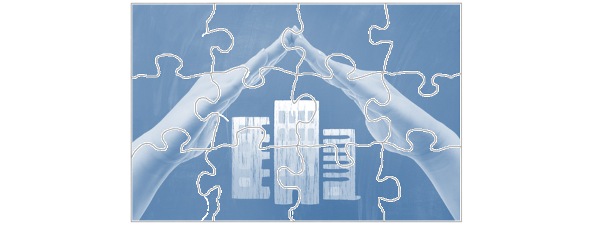 Puzzle of hands protecting business buildings